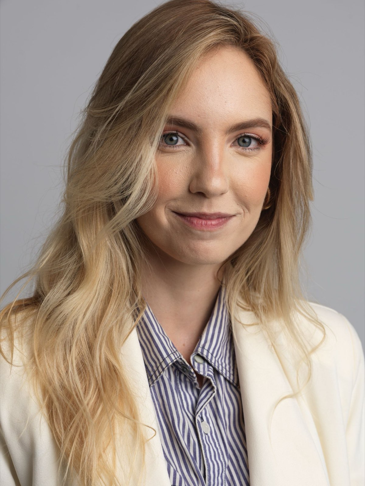 A person photographed against a plain light background for an ID photo