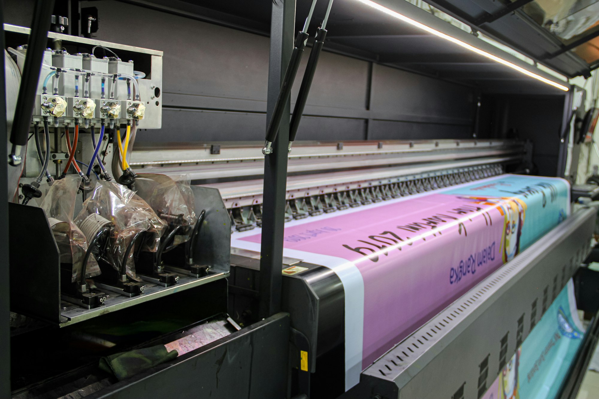 Commercial printing press running large sheets of paper
